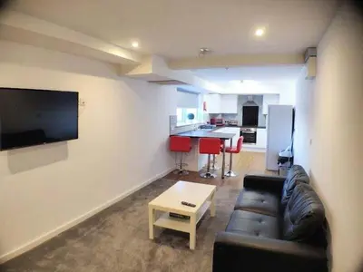 a living room with a couch and a table at Liverpool Stays - Kempston Court in Liverpool