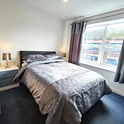 a bedroom with a large bed and a window at Liverpool Stays - Kempston Court in Liverpool