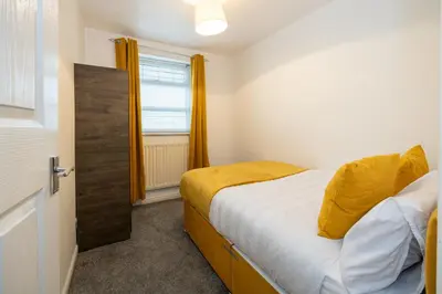 a small bedroom with a bed and a window at Church Street Cottage Great Harwood in Great Harwood