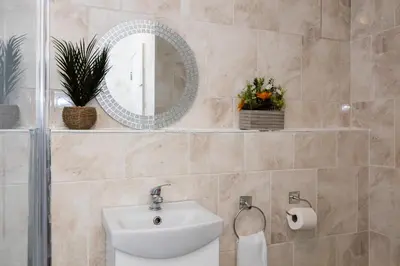 a bathroom with a sink and a mirror at Church Street Cottage Great Harwood in Great Harwood
