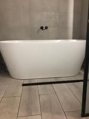 a white bath tub sitting in a bathroom at Beach Flat Lytham St Annes in Lytham St Annes