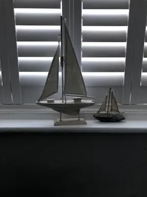 two miniature boats sitting on a window sill at Beach Flat Lytham St Annes in Lytham St Annes