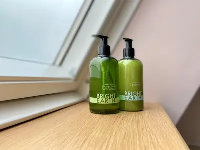 two green bottles sitting on top of a table at The Bath Rooms in Morecambe