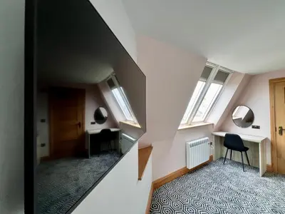 an attic room with two desks and two windows at The Bath Rooms in Morecambe