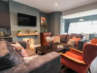 a living room with two couches and a table at Eden Bay Retreat in Morecambe