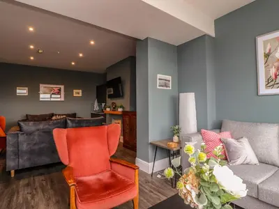 a living room with a couch and a chair at Eden Bay Retreat in Morecambe