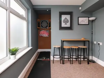 a room with a table and stools next to a window at Eden Bay Retreat in Morecambe