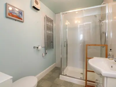 a bathroom with a shower and a toilet and a sink at Eden Bay Retreat in Morecambe