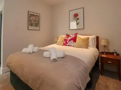 a bedroom with a large bed with two pillows at Eden Bay Retreat in Morecambe