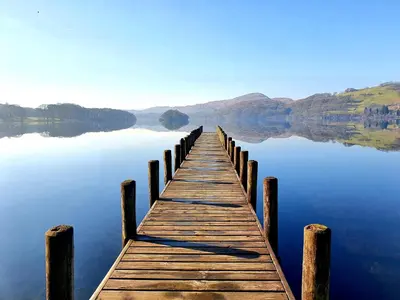 a wooden dock on a body of water at Buxton Mews in Ulverston