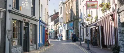 a city street with people walking down the street at Buxton Mews in Ulverston