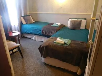 a room with two beds in a room at Iona Hotel in Blackpool