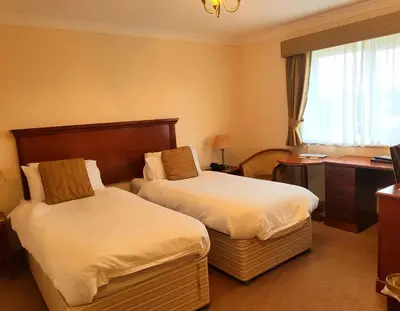 a hotel room with two beds and a desk at The Chetwynde - Self Check In HMO in Barrow in Furness