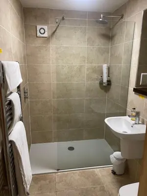 a bathroom with a shower and a sink at The Chetwynde - Self Check In HMO in Barrow in Furness