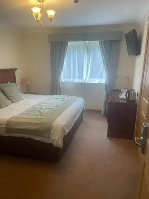 a bedroom with a large bed and a window at The Chetwynde - Self Check In HMO in Barrow in Furness