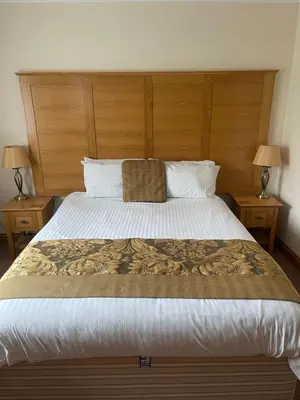 a bedroom with a large bed with two night stands at The Chetwynde - Self Check In HMO in Barrow in Furness