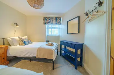 a bedroom with two beds and a blue nightstand at 40 The Gill - Ulverston Town Centre in Ulverston