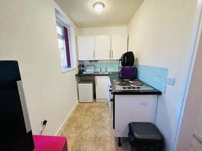 a small kitchen with a stove and a counter top at Luminous Suites in Blackpool