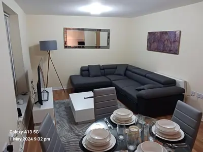 a living room with a couch and a table at POTTERS LOGDE LIVERPOOL by Edl Ventures Ltd in Liverpool