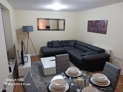 a living room with a couch and a table at POTTERS LOGDE LIVERPOOL by Edl Ventures Ltd in Liverpool
