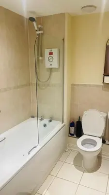 a bathroom with a shower and a toilet and a tub at POTTERS LOGDE LIVERPOOL by Edl Ventures Ltd in Liverpool