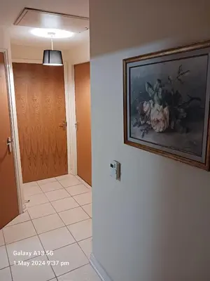 a hallway with a painting of flowers on the wall at POTTERS LOGDE LIVERPOOL by Edl Ventures Ltd in Liverpool