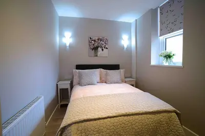 a bedroom with a large bed in a room at Twelve Apartments in Blackpool