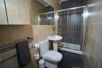 a bathroom with a toilet and a sink at Twelve Apartments in Blackpool