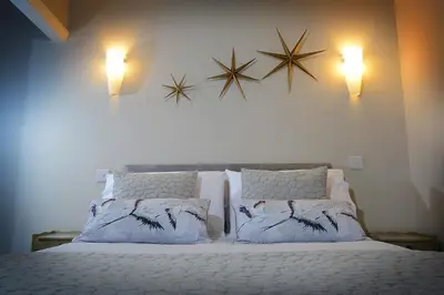 a bedroom with a bed with pillows and stars on the wall at Twelve Apartments in Blackpool