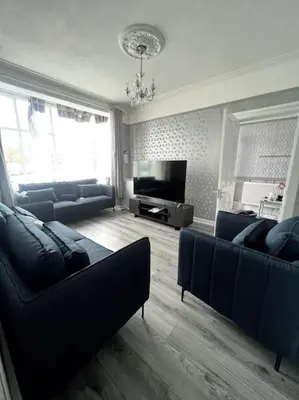 a living room with blue couches and a television at No. 206 - Spacious 5 Bed in Liverpool