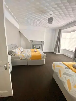 a bedroom with two beds and a window at No. 206 - Spacious 5 Bed in Liverpool