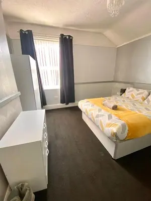 a small bedroom with a bed and a window at No. 206 - Spacious 5 Bed in Liverpool