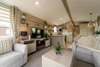 a living room with a couch and a table at Wiswell View Lodge: Pendle View Holiday Park in Clitheroe