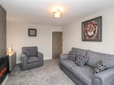 a living room with a couch and a chair at 12 Merefell Road in Carnforth