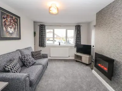 a living room with a couch and a fireplace at 12 Merefell Road in Carnforth