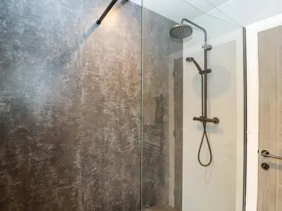 a shower with a glass door in a bathroom at 12 Merefell Road in Carnforth