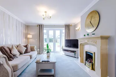 a living room with a couch and a fireplace at Damson House- Spacious, Modern 6 bedroom Executive House - Ideal for Work Teams or Multi-Generational Families in Great Mitton