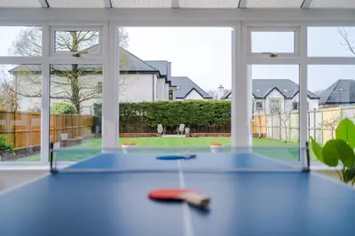 a room with a table with a view of a yard at Damson House- Spacious, Modern 6 bedroom Executive House - Ideal for Work Teams or Multi-Generational Families in Great Mitton