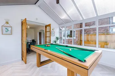 a pool table in a living room with a pool at Damson House- Spacious, Modern 6 bedroom Executive House - Ideal for Work Teams or Multi-Generational Families in Great Mitton