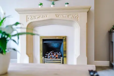 a fireplace with a pile of balls in it at Damson House- Spacious, Modern 6 bedroom Executive House - Ideal for Work Teams or Multi-Generational Families in Great Mitton