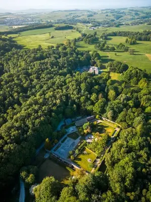 an aerial view of a house in the middle of a forest at Victorian Copper Cottage in Lancaster