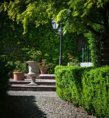 a street light next to some bushes and stairs at Victorian Copper Cottage in Lancaster