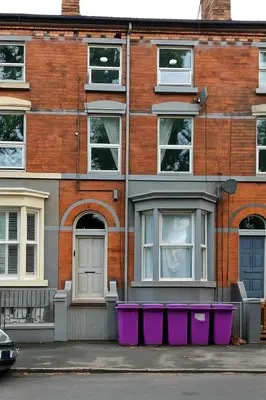 a brick building with purple doors and windows at Sidemersey Livings - Botanic Residence in Liverpool