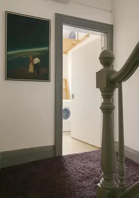 a hallway with a painting of a man and a woman at Sidemersey Livings - Botanic Residence in Liverpool