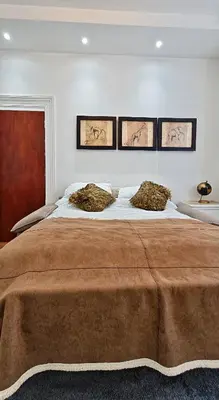 a bedroom with a large bed with three pictures on the wall at Sidemersey Livings - Botanic Residence in Liverpool