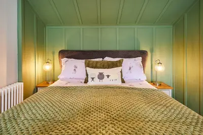 a bedroom with a large bed with two lamps at Host & Stay - Lime Tree House in Holme