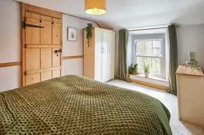 a bedroom with a large bed and a window at Host & Stay - Lime Tree House in Holme
