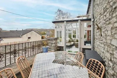 a patio with a table and chairs on a balcony at Host & Stay - Lime Tree House in Holme