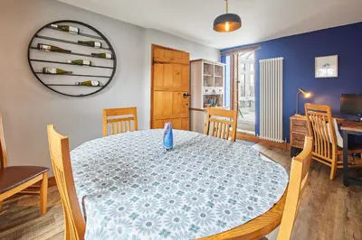 a dining room with a table with a blue and white table cloth at Host & Stay - Lime Tree House in Holme