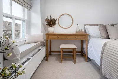 a bedroom with a desk and a bed with a mirror at Wharton Cottage, Cartmel, Lake District Retreat - Ridgestone in Cartmel